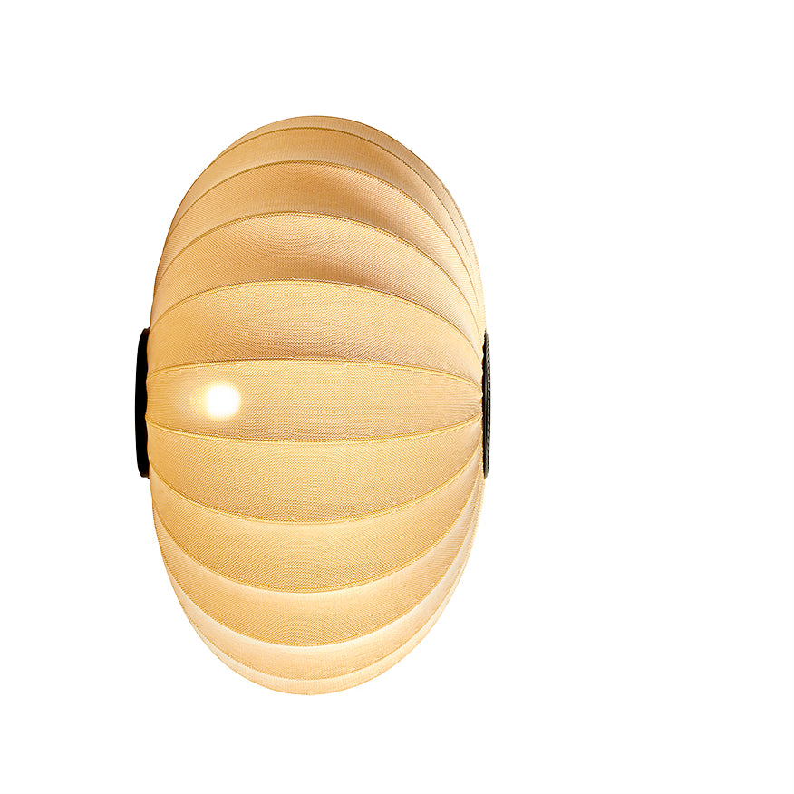 Loftlampe i gul og sort med lys i, set fra siden af