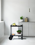Et sort rullebord med køkkentilbehør på