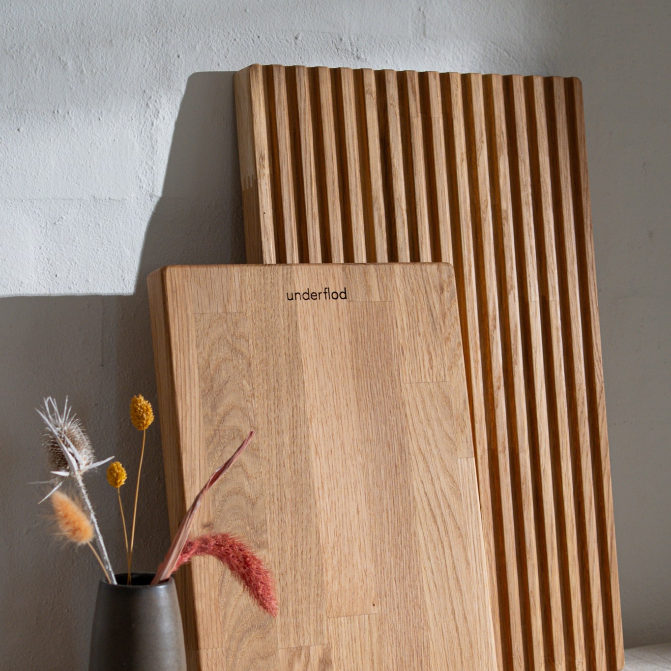 Billede af tørret blomster i vase og ét lille skærebræt og ét stort skærebræt 
