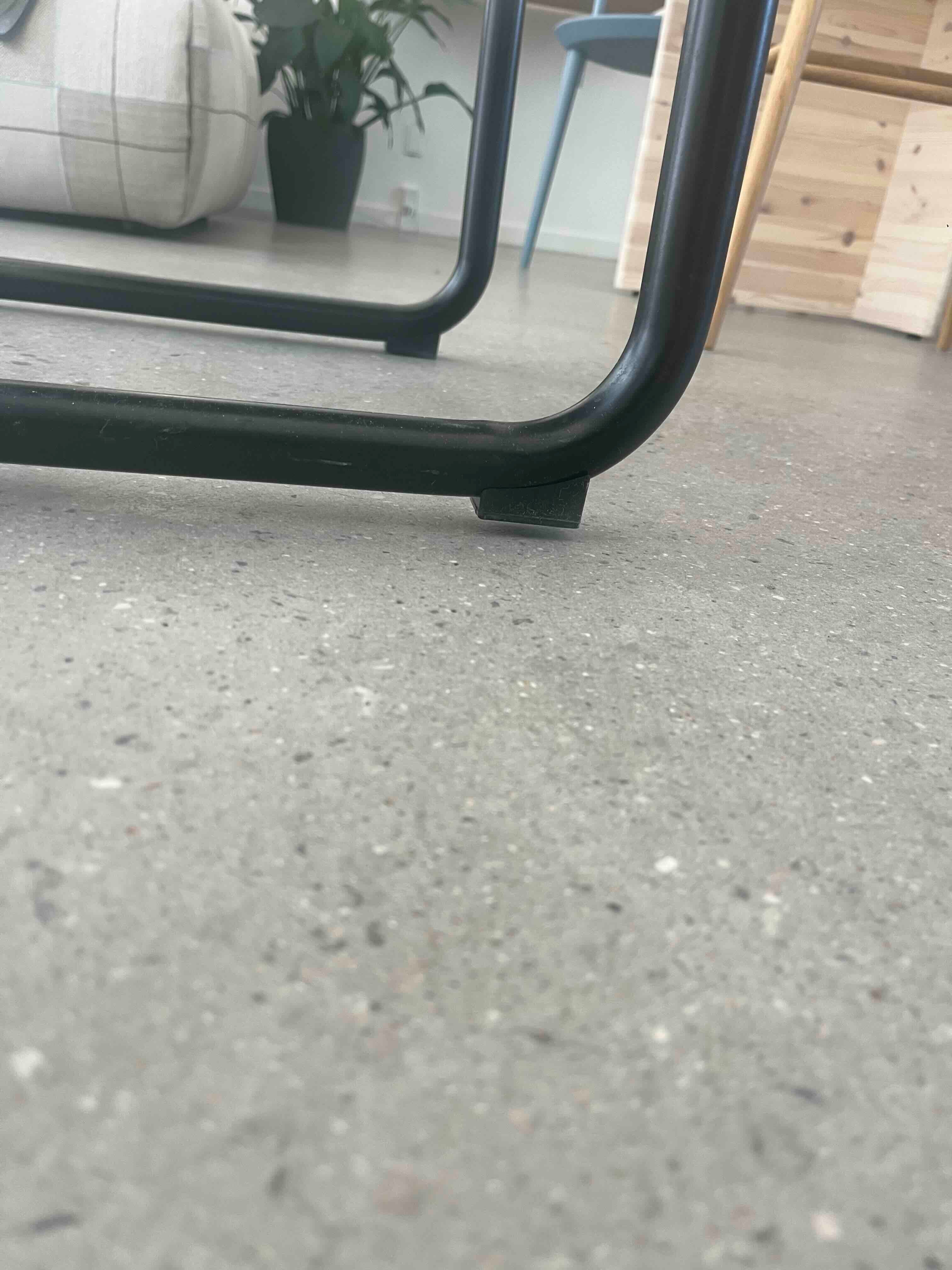 Nærbillede af stoleben i sort metal